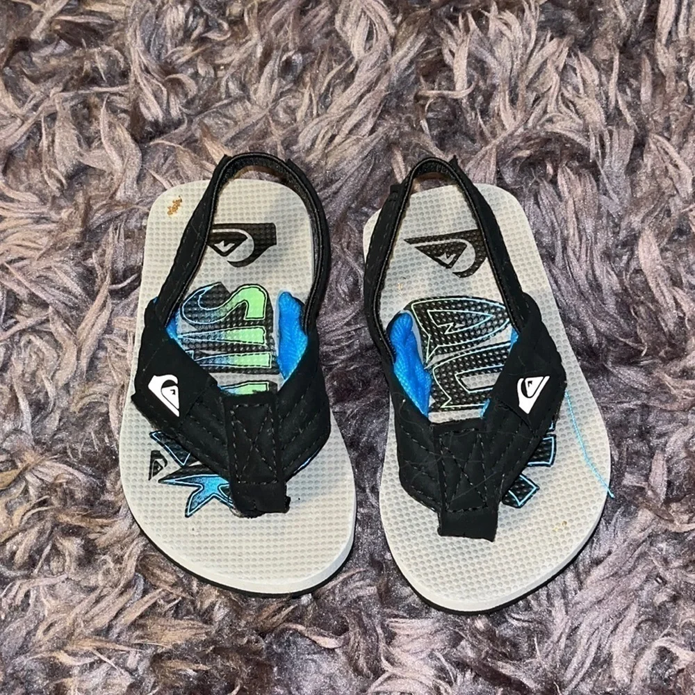 Quicksilver black and blue flip flops for boys.